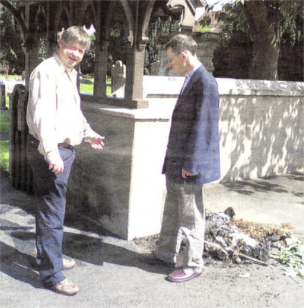 Basil McCrea MLA and Rev. John Rutter of St. Aiden's Church of Ireland, Glenavy survey the damage following the fourth arson attack on the Church in four months.