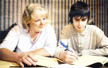 Karen Nesbitt and son David, from Crumlin, studying mathematics at their dining table. David, aged 16, has never been to secondary school. US5008-531cd