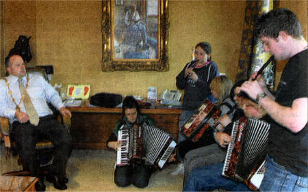 Lisburn Mayor Councillor James Tinsley enjoys some traditional music played by the visitors from Raphoe.