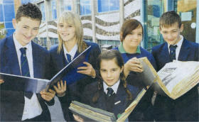 Fort Hill College pupils look back at photographs and newspaper cuttings from the past. The books are part of the school's history, collected and compiled by former Principals Miss Mary-Jane Gray and Miss Geraldine Tigchelaar OBE. Included are Adam Higginson, Natalie Cairns, Amy McMullan, Katrina Hawthorne and Kyle McCullough. US4208-530cd