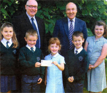 Emma Frazer, Connor Brennan, Frances Arnott, Matthew McMahon, Victoria Lee along with Mr McClean present a cheque to Paul Kane of Trocaire as part of St. Aloysius ongoing charity fun raising. A total of �5,000 was raised during Lent 2008.