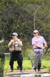 A moment of excitement as a fish is netted during the Casting for Recovery Retreat.