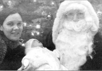 Santa at the Museum with five week old baby Mya Culbertson and her mother Mrs Denise Culbertson.