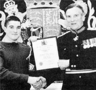 Stewart Mitchell who will serve as the Lord Lieutenant's Cadet for the County of Down receives his award from Colonel Hall.