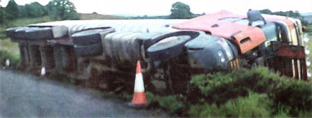 The lorry lies toppled on the side of the Edentrillick Road.