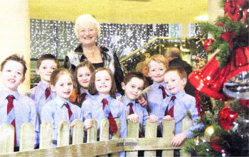 Dame Mary Peters with children from Pond Park Primary who helped spread some festive cheer with songs at the recent 'Mary' Christmas event at the Island Centre held by the Mary Peters Trust. The P4 and P5 children pictured with Dame Mary are (from left) Callum Patterson, Ben Thompson, Lucy Gillanders, Leigh Gordon, Rebecca Lynn, Thomas Cherry, Peter McCrea and Patrick Lynn.