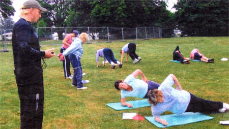 Coach David Bradford, helps put 18 women through their paces in their endeavor to tone up and slim down.