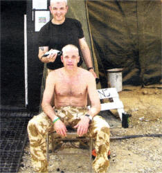 Operational Resident Barber Corporal Alan Yates gets to work in Afghanistan.