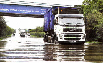 A lorry makes its way through floodwater on the Glenavy Road. Earlier five people had to be rescued after their cars were trapped in the floods. US3308-540CD