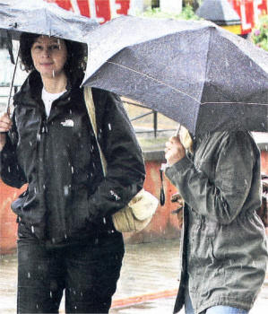 Shoppers brave the horrid August weather in Lisburn during heavy rain on Tuesday. US3308-548cd