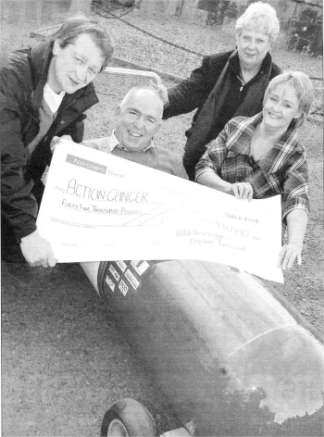 Hillsborough Oyster Festival Committee Members Derek Patterson and Shane Smith present Action Cancer's Norma Bell MBE and Head of Prefessional Services Geraldine Kerr with a cheque for �45,000.