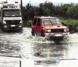 Vehicles make their way through the flooded Moira Road. US3308- 116A0