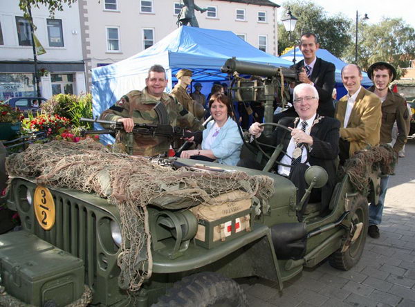 Mayor of Lisburn City Council, Councillor Allan Ewart pictured behind the wheel of war vehicle with L to R: David McCallion (War Years Remembered), Councillor Jenny Palmer, 