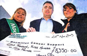 Rosaleen McAtamney Fundraising Co-ordinator Macmillan Cancer Support receives a cheque of £8350 from Paul Meredith and Lesley Banks who raised the money when they climbed Mount Kilimanjaro and other fund raising events. US4709-115A0