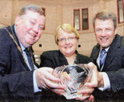 Councillor Margaret Tolerton receiving a Nabarro award (for 50 years of life with insulin) from Deputy Mayor Paul Porter and Hugh McCaughey, chief executive of the South Eastern Trust. US4109-519cd