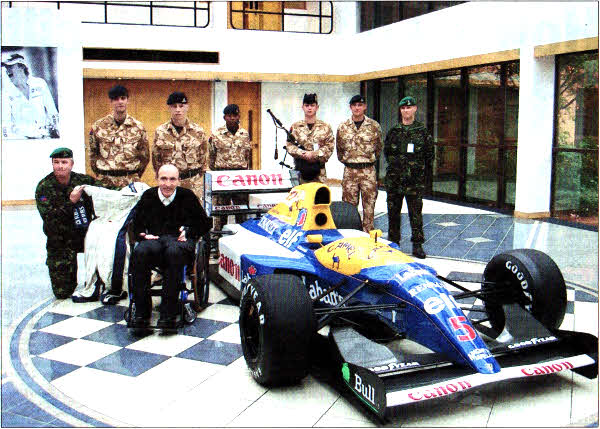 Soldiers from Thiepval Barracks visited Williams Fl headquarters, met Sir Frank Williams and saw Nigel Mansell's racing car. Left to Right Forefront -Sgt Will Bennett AGC (SPS), Sir Frank Williams. Left to Right Background - Gunner Aaron Carmichael, Gunner Martin Barker, Gunner Matthew Chipande, LBdr Allan Summers, Gunner Christy Roberts and W02 (SQMS) Colin Morrison. US4309-