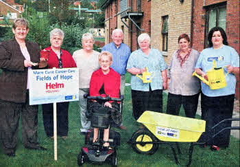 At the launch of Helm Housing's exciting new partnership with Marie Curie Cancer Care are residents and staff of Pine Tree Manor in Twinbrook with (far left) Helm Housing Group Chief Executive Jean Fulton and (far right) Marie Curie's Community Fundraiser Lesley Wright.