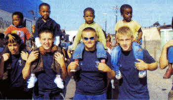 Wallace pupils Finbar Foxwell, Colin Munn, Kyle McCall and David Scott with children from Langa township.