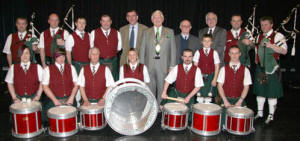 Phonsie Travers (Donegal), Councillor Ronnie Crawford (Mayor), Eddie Mullan (Band Chairman) and Councillor Allan Ewart pictured with St Patrick’s Pipeband, Annsborough.