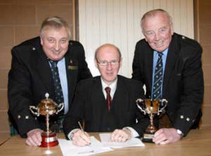 Ken Stewart - RSPBA NI piping adjudicator pictured with Roy McCullough - RSPBA NI Trophy Officer (left) and Fred Walker - RSPBA NI President (right).