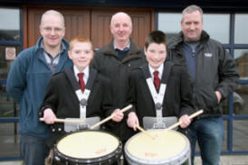 Cleland Memorial drummers Adam Morrow and Andrew Thompson pictured with Adam’s father Neville (left) and Andrew’s father Alan (right) and grandfather Richard Coffey (centre).