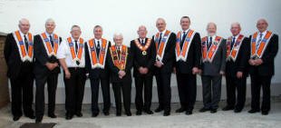 n ‘Ulster  L to R: Brothers - Jim Ferguson (District Lay Chaplain), Jim Martin (Outside Tyler), Norman Hall (Inside Tyler), Robert Orr (District Treasurer), George Morrison (Past District Master), Fred Willoughby (Worshipful District Master), Tom Kerr (Deputy District Master), Jonathan Beattie (District Secretary), Jim Halliday (District Lecturer 2), Henry Smyth (Assistant Treasurer) and William Braithwaite (Assistant Secretary).