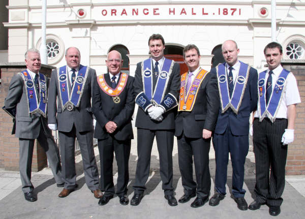 Marc Pinkerton (centre of picture) and Fred Willoughby (third from left) are pictured at Lisburn Orange Hall with lodge members Lagan Valley MP Jeffrey Donaldson and L to R: Marc’s uncle Wilfie, his father Noel, brother Lee and cousin Stuart.