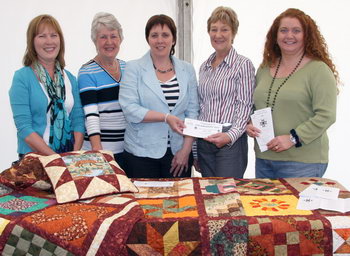 Lagan Valley Patchwork Guild ladies pictured selling ballet tickets for a 25th anniversary quilt at the Farmer’s  Market in Castle Gardens.  L to R: June Lohoff, Hilda Hamilton, Jenny Palmer (Lisburn City Council Economic Development Chairman), Margaret Rogan and Karen Armstrong.