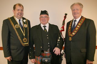 Closkelt piper David Winton pictured with Sir Knt David Burleigh (Worshipful District Master) and the Most Worshipful Sir Knt Millar Farr (Sovereign Grand Master).