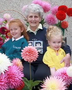 Mrs Joan Laverick, Secretary of the North of Ireland Dahlia Society, pictured with some young visitors to the show