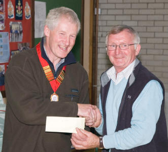 North of Ireland Dahlia Society President, David McWilliam presents Martin Lawlor with the NIDS Silver Spoon award for the best exhibit in Classes 31-39, Dec and semi-cactus cultivars, at the Annual Dahlia show in Hillsborough.