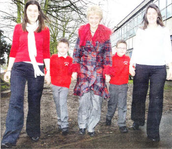 Seven-year-old twin brothers Joel and Luke Cherry who raised £200 in a Sponsored Walk for MS. The boys are carrying the tradition from their mother Judith Cherry and her twin sister Nicole Neville who also took part in Walk For MS as children. Also pictured is Ann Walker of Action MS. US1309-134A0