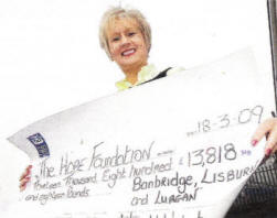 Bernie Walsh of Weight Watchers with a cheque of £13818 for the Hope Foundation. US1309-137A0 Picture By: Aidan O'Reilly