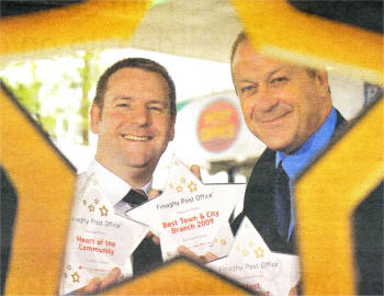 Alan Gilliland, manager of Finaghy Post Office branch receiving his awards from Terry Doherty of Office Ltd in the Best Post Office Awards 2009.