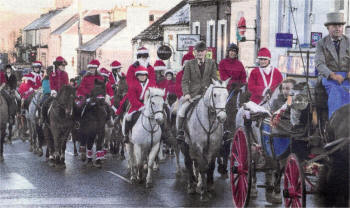 The horse-drawn carriage driven by George Fawcett and Jim Creighton lead the riders up the Main Street in Saintfield during the Christmas Charity Pleasure Ride.