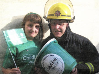 Charity car wash co-ordinator Jim McGann from the NI Fire and Rescue Service along with his daughter Beth. The event takes place at Crumlin Fire Station with all proceeds going to NSPCC/Childline.