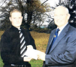 John Craig, Crumlin, receiving a £1,000 bursary from Angus Cuthbert of the Ulster Farmers' Union.