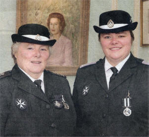 Jennifer Johnston and her daughter Tracey, members of the Lisburn Q Division of St. John Ambulance celebrate their awards at the Investiture and Awards ceremony. Jennifer was admitted to the Order of St. John which is an Order of Chivalry and Tracey received the 'Service Medal of the Order' accolade for completing 12 years of efficient service for St. John Ambulance.