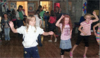 Local children have a go at some Scottish dancing.