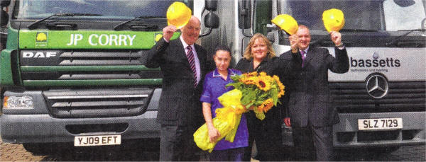 Pat McGeown, JP Corry Sales Director and Robert McGookin, Manager of Bassetts, present a bunch of sunflowers to Fiona Stephens, Corporate Fundraiser at the Hospices and Deborah Sharkey, Staff Nurse at Northern Ireland Hospice to signify the launch of the new charitable partnership. US3209-Hospice