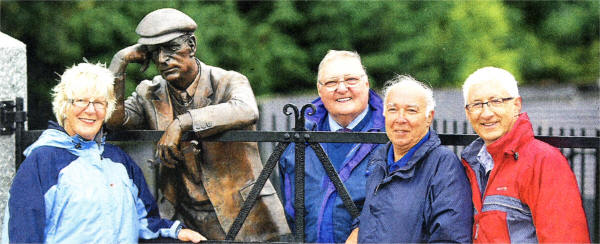 Mrs Ester Erwin, from the Dr Amara branch of Cancer Research UK, with Harry Ferguson Celebration Committee members George Cromie, secretary; Eric Jess, chairman; and Bill Forsythe, public relations, pictured beside a statue of the famous tractor inventor at his former home.