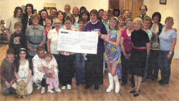 Members of Brookmount Dance Ranch and Belsize Kickers Line Club's present charity representative Irene Maitland with a cheque for £2400 for Northern Ireland Children's Hospice Charity Night.