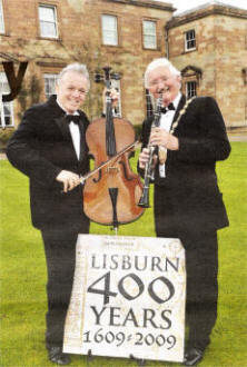 BBC's Noel Thompson and Lisburn City Council Mayor, Councillor Ronnie Crawford celebrate the announcement that the 2009 Proms in the Park will take place at Hillsborough Castle