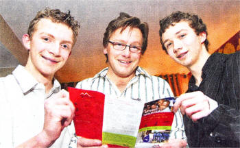 Gavin Bate (centre) from the Moving Mountains charity, along with Mark McCardy and Joshua Baird, studying trip details. During a special fund-raising evening at Rockmount Golf Club, Mr Bate explained how Moving Mountains is helping build futures through long-term support. US0909-501cd