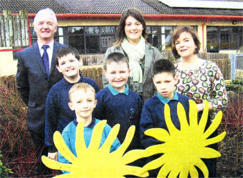 Nicola Kelly and pupils Aaron Claxton, Thomas Ward, Junior Rooney and Christopher Crossey from Parkview Special School show off the school's new solar panels to Emma Gribben from NIE Energy and Billy Mills from the South Eastern Education and Library Board.