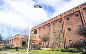 The flag flies at half mast at Lisburn PSNI station and, left, Chief Inspector David Moore