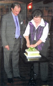 President Jacqui Townsley cutting the 60th Anniversary cake with Chairman Derek Alexander looking on.