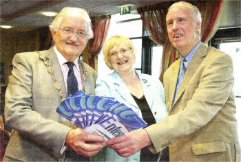 Irene Orrn centre, chair of Lisburn Access Group, with Lisburn mayor Ronnie Crawford and David Mann, vice chair of the Access Group, at the launch of a new leaflet and logo for the group. US2009- 540c