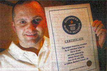 Allister Brown with the official certificate he received from Guinness World Records for recording the longest drumming marathon. US0509-115A0