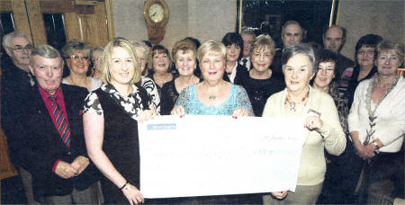 At Rockmount Golf Club, Action Cancer Community Appeals Officer Kathryn Gibson receives a cheque for £55,000 from Lisburn Action Cancer's Norma Bell US0609-401PM Pic by Paul Murphy